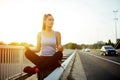 Woman relaxing next to a busy road, challenge concept