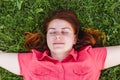 Beautiful young woman lies on the grass. Fresh natural summer concept. View from the top Royalty Free Stock Photo