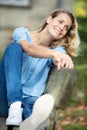 woman relaxing on park bench with takeaway coffee Royalty Free Stock Photo