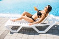 Woman relaxing at the poolside with cocktail. Summer time Royalty Free Stock Photo