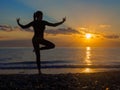 Woman relaxing by practicing yoga near the sea. Calmness and lonelines. Royalty Free Stock Photo