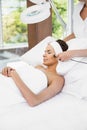 Woman relaxing while receiving facial massage Royalty Free Stock Photo