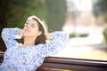 Woman relaxing and resting in a bench in a park Royalty Free Stock Photo