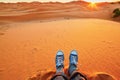 Woman relaxing on sand dunes and looking at sunrise in Sahara Desert Royalty Free Stock Photo