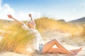 Woman relaxing on sand dunes. Royalty Free Stock Photo