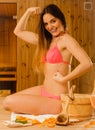 Woman relaxing in sauna showing off muscles. Royalty Free Stock Photo