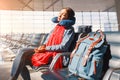 Relaxing and sleeping with neck pillow at airport terminal awaiting the delayed flight, transportation and travel concept