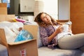 Woman Relaxing On Sofa With Hot Drink In New Home Royalty Free Stock Photo