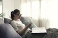 Woman relaxing on the sofa and watching pictures in the photo album