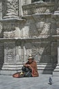 Woman relaxing on a street. Old building in background