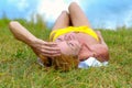 Woman relaxing sunbathing on the grass Royalty Free Stock Photo