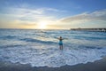 Woman relaxing at sunrise on the beach. Royalty Free Stock Photo