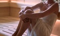 Woman relaxing and sweating in Finnish sauna Royalty Free Stock Photo