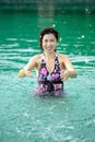 The woman relaxing in the swimming pool