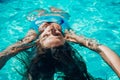 Woman relaxing swimming pool. Happy woman in a blue swimsuit floating in the pool, look form above Royalty Free Stock Photo