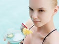 Woman relaxing on the swimming pool on sunny day. Girl relaxing at luxury travel resort