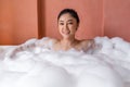 Woman relaxing and takes bubble bath in bathtub with foam Royalty Free Stock Photo