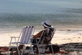 A woman relaxing on a white sandy tropical beach