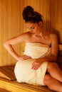 Woman relaxing in wooden sauna room Royalty Free Stock Photo