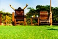 Woman relaxing on wooden sunbed on green artificial grass and looking the blue sky