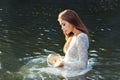 Woman releases a goldfish.