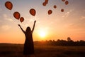 Woman releasing balloons. Generate AI Royalty Free Stock Photo