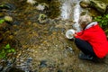 Woman releasing Chum fry into Kanaka Creek