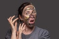 The woman removes the cosmetic mask from her face Royalty Free Stock Photo