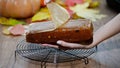 The woman removes pumpkin bread from baking form