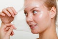 Woman removing facial peel off mask. Royalty Free Stock Photo