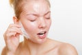 Woman removing facial peel off mask. Royalty Free Stock Photo