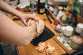 Woman removing fat from fresh Capon Chapon cockerel meat on kitchen wooden top