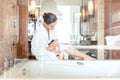 Woman removing hair by shaving her legs in bathroom of hotel Royalty Free Stock Photo