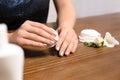 Woman removing nail polish at table Royalty Free Stock Photo