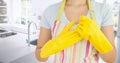 Woman removing rubber gloves in kitchen Royalty Free Stock Photo