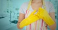 Woman removing rubber gloves in kitchen Royalty Free Stock Photo