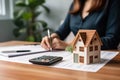 Woman renter calculates finances using a calculator for business managing money house loan rent payments and taxes in a real