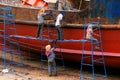 Woman repair old ship