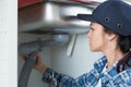 Woman repairing bathroom sink pipe Royalty Free Stock Photo