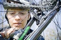 Woman repairing bicycle outdoors