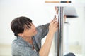 woman repairing chair at home