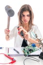 Woman Repairing Computer with Hammer, Service Center, Electronics Repair Service Royalty Free Stock Photo