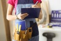 Woman repairman writing paper on clipboard closeup