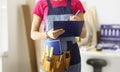 Woman repairman writing paper on clipboard closeup