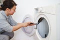 the woman repairs the washing machine, disassembles into parts