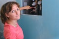 A woman repairs the water supply in the apartment with a wrench. Sewer pipes and water meters in the house, close-up