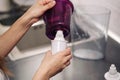 Woman replacing filter in a water pitcher. Female hand removes an old tap water purification cartridge from a jug. Royalty Free Stock Photo