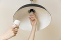 Woman replacing light bulb at home. Power save LED lamp changing Royalty Free Stock Photo