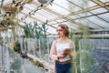 Woman researcher standing in greenhouse, using tablet. Royalty Free Stock Photo