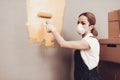 Woman in Respirator in Uniform Paint Gray Wall.